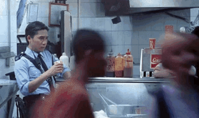 GIF image from Wong Kar-wai's Chungking Express, 2 main characters hanging out at the sandwich shop